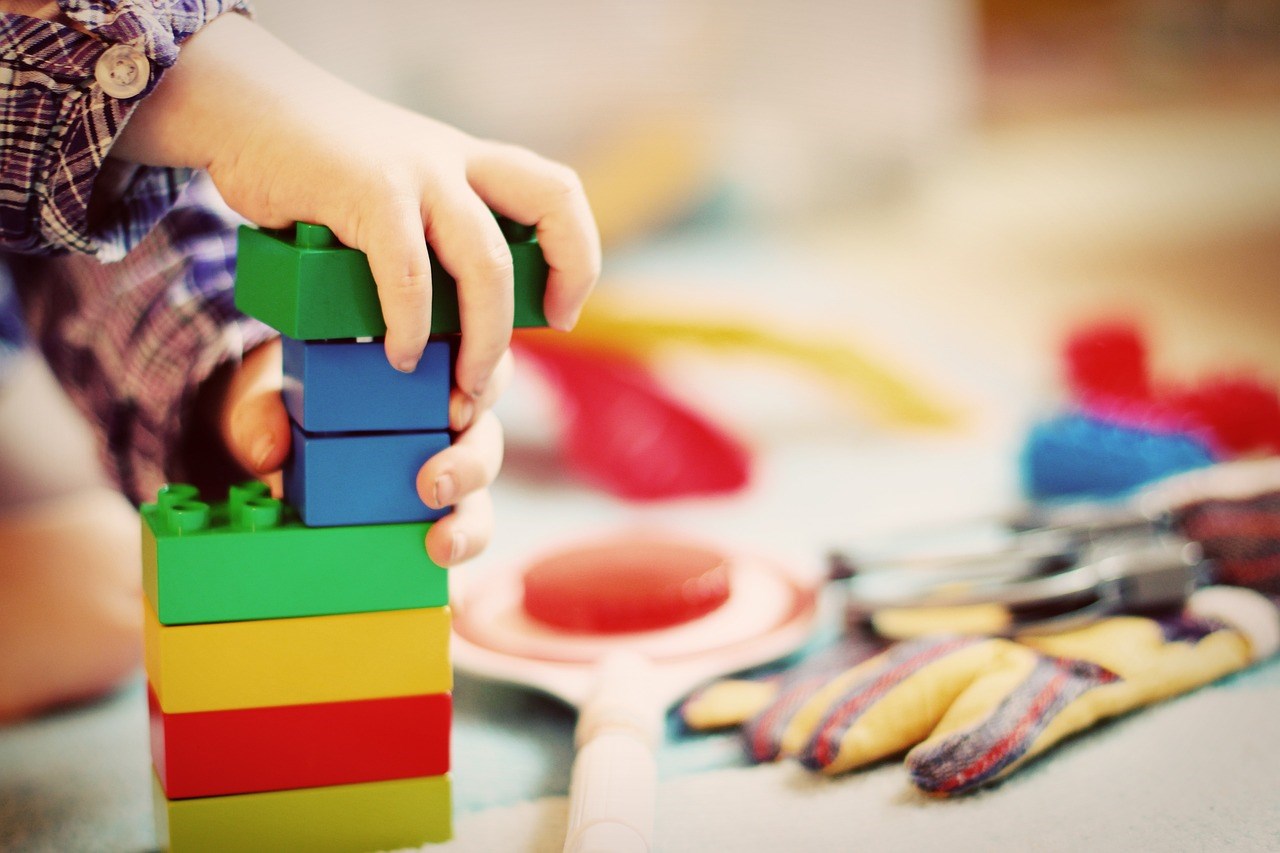 Child hands stacking blocks