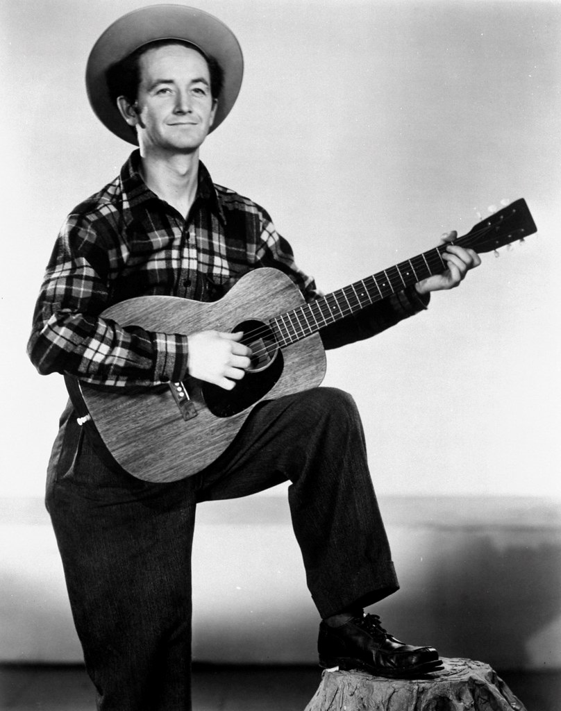 photo of young Woody Guthrie playing the guitar