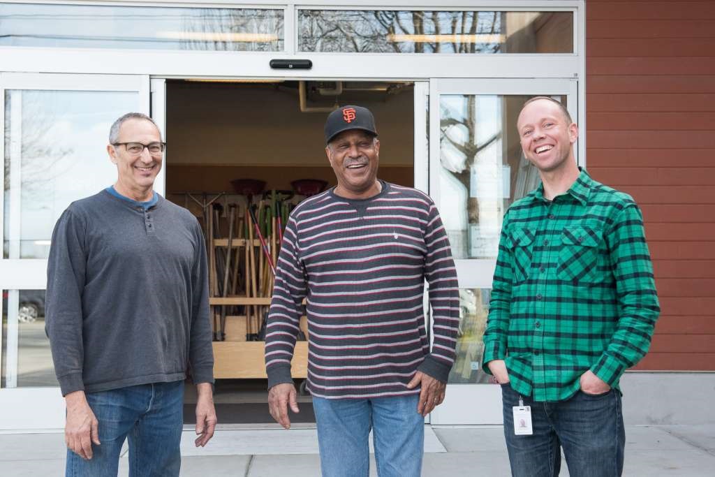 photo of three staff members standing in front of the Berkeley Public Tool Lending Library