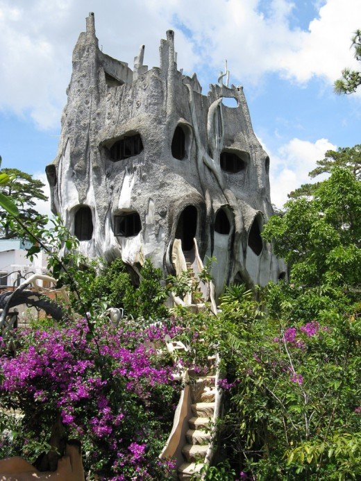 This grey "crazy house" vaguely resembles the stump of a giant, gnarled tree.