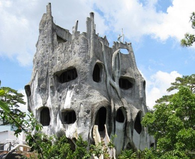 This grey "crazy house" vaguely resembles the stump of a giant, gnarled tree.