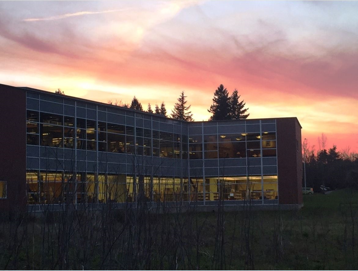 photo of library staff with two carts of books