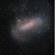 A somewhat indistinct galaxy with a central bar and a spiral arm.