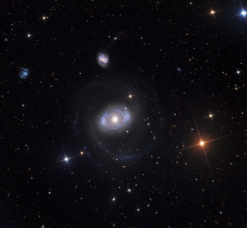 A galaxy with faint arms spiraling out from the center, which resembles an eye.