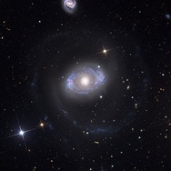 A galaxy with faint arms spiraling out from the center, which resembles an eye.
