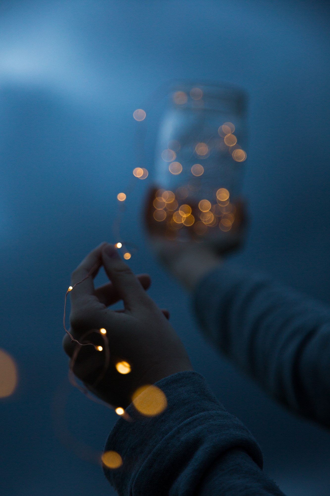 Person Holding Mason Jar with Lights