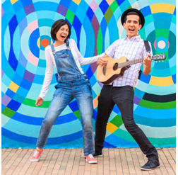 photo of Andres and Christina standing in front of a colorful mural