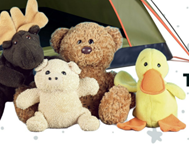 Stuffed animals (moose, pig, bear and duck) sitting in front of a tent.