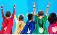 Picture taken from behind 5 children with their hands in the air and wearing different colored superhero capes