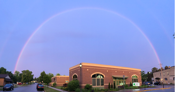Picture of a rainbow over the E.D. Locke Public Library building