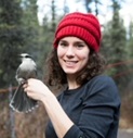 Picture of Dr. Kaeli Swift holding a bird.