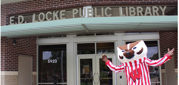 Picture of Bucky Badger in front of the entrance to E.D. Locke Public Library
