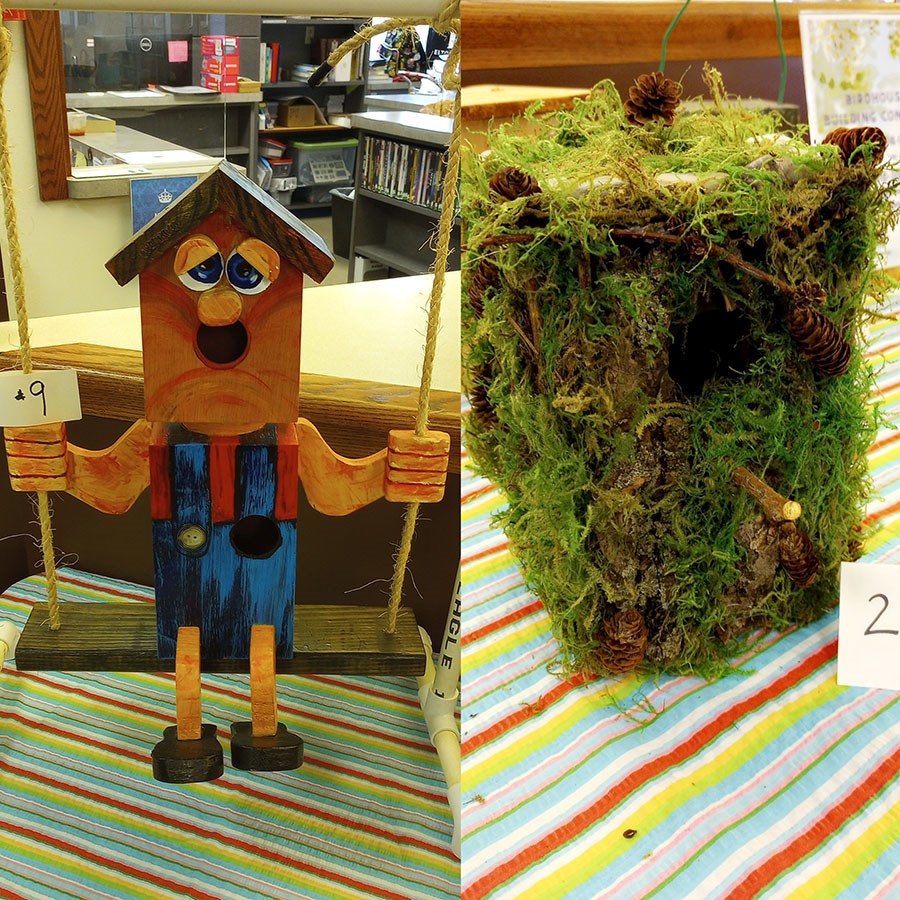 Two birdhouse designs that were selected as winners. The birdhouse on left looks like a person sitting on a swing with an entrance hole at the mouth and another entrance hole as a button on overalls. The birdhouse on the right is covered in moss and mini pinecones.