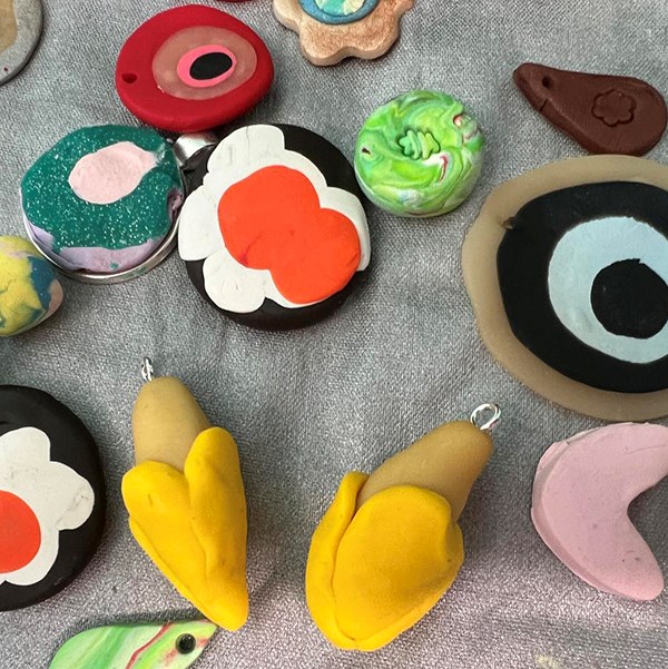 A colorful collection of beads in different shapes made from polymer clay.