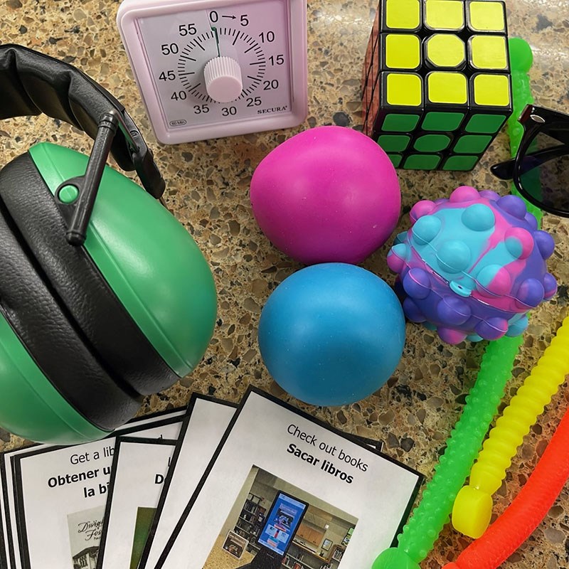Noise cancelling headphones, timer, stress balls, fidget toys, Rubik's cube items from Neurodiversity Kit