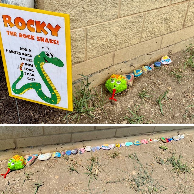 Photo of painted rocks outside on the ground forming a chain of rocks to become a snake named "Rocky"