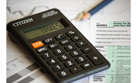 calculator, pencil and tax form