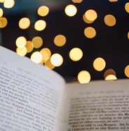 open book with gold bokeh in background