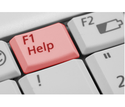 Close up of a computer keyboard with a red key that reads "F1 help"