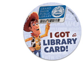 Round image of Woody from Toy Story holding a library card and text that reads "I got a library card!"