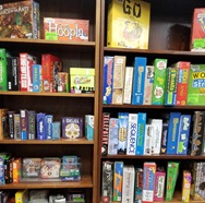 Photograph of the board game shelves at West Slope library