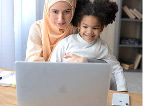 Image of a mom and kid watching a storytime on a computer