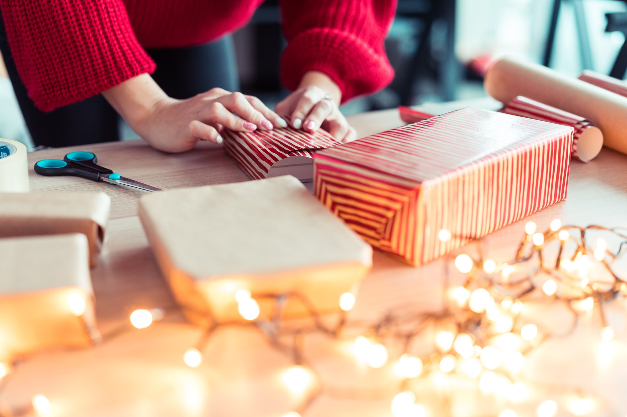 Hands of women wrapping gifts