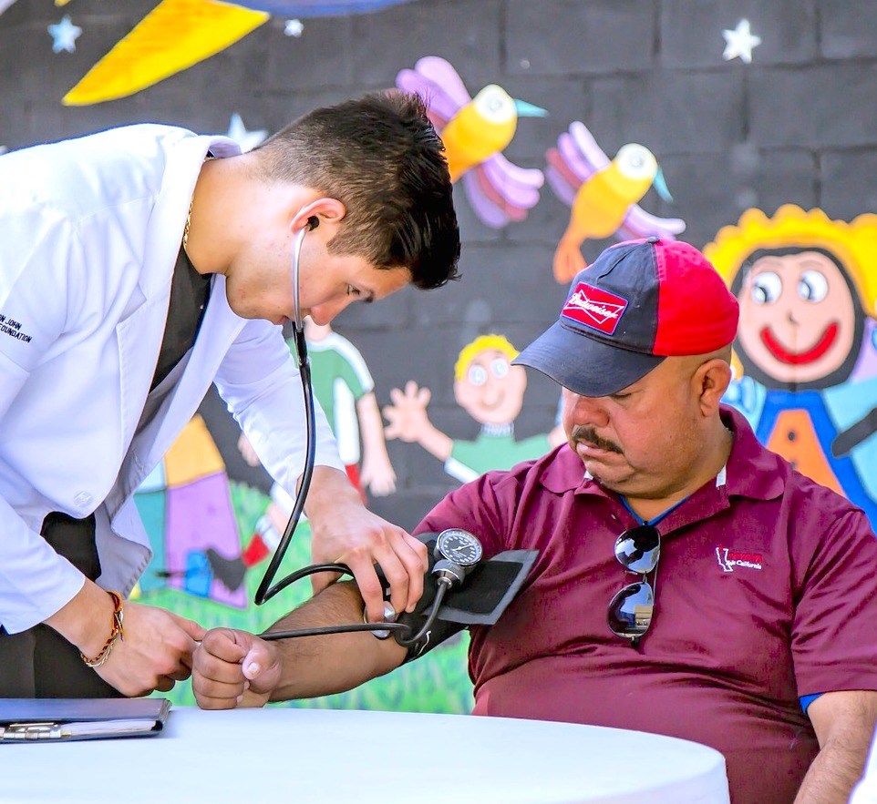 nurse checking patient's blood pressure outside