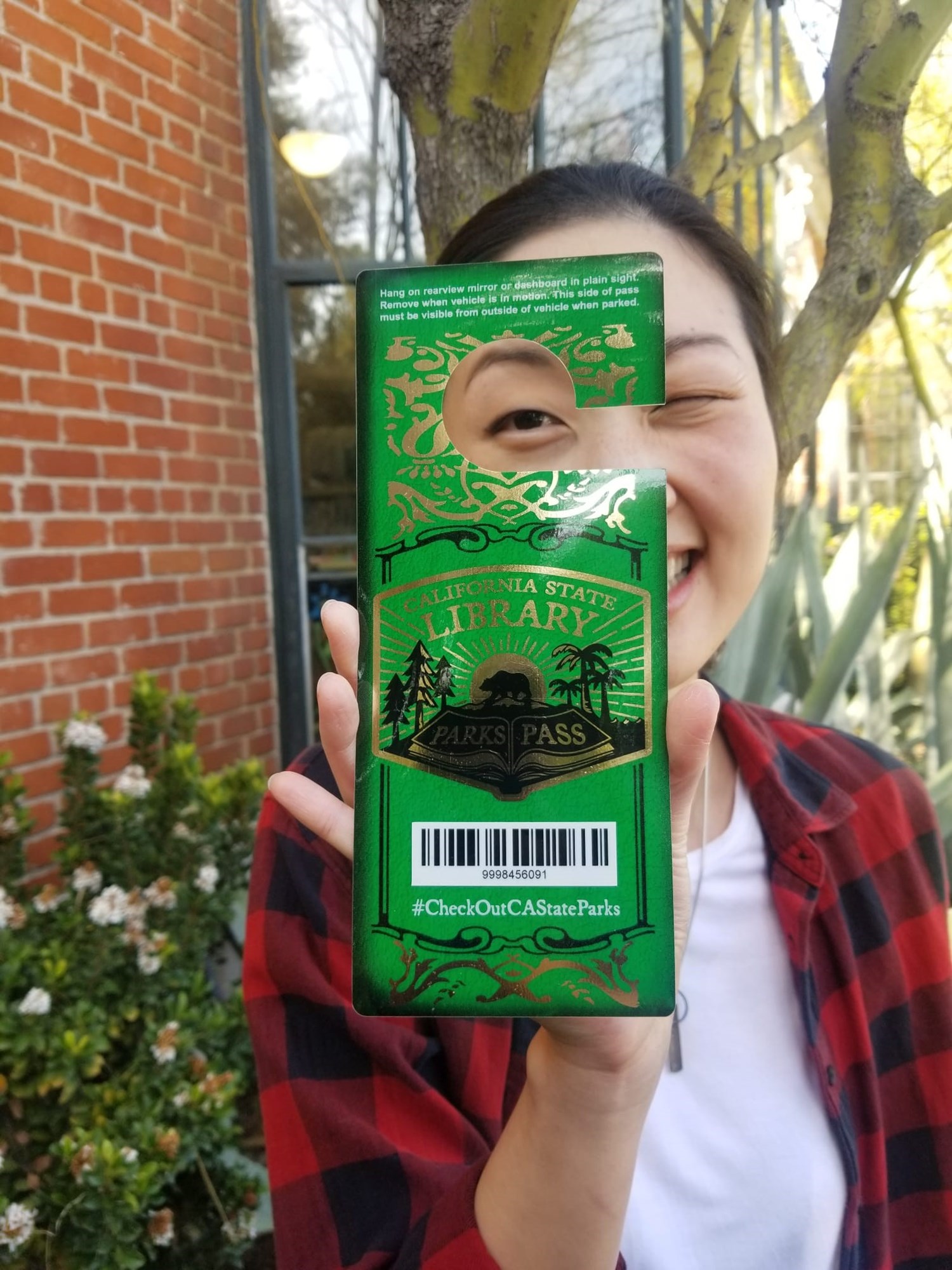 young woman holding park pass