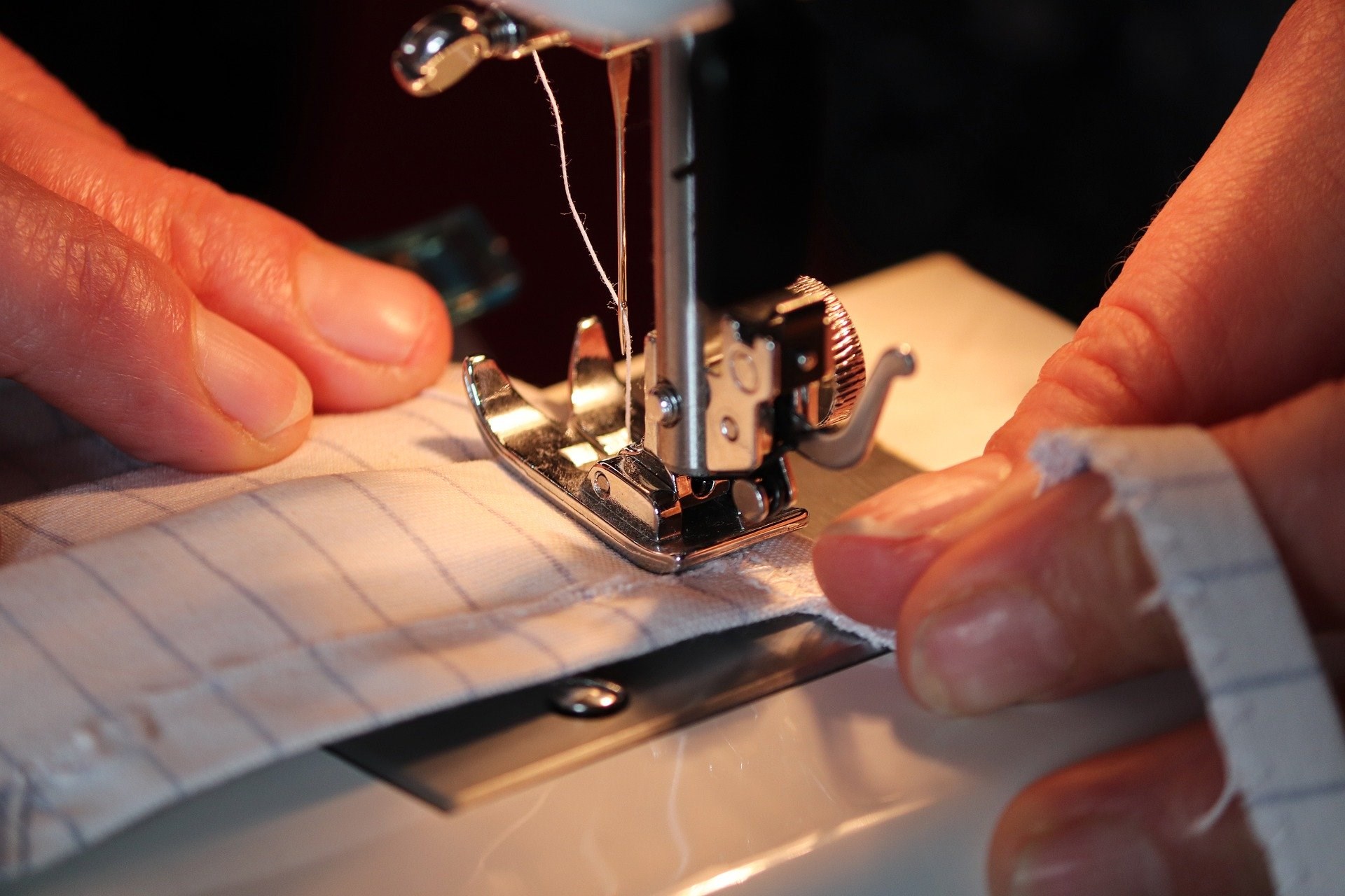 Hands using sewing machine