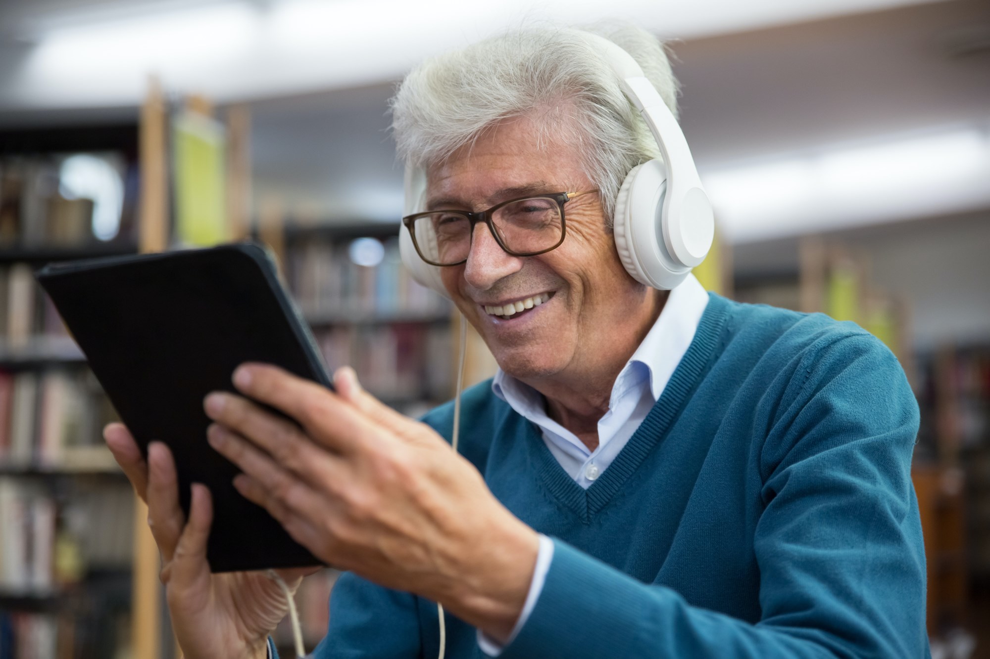 Senior Man listening to an audio book