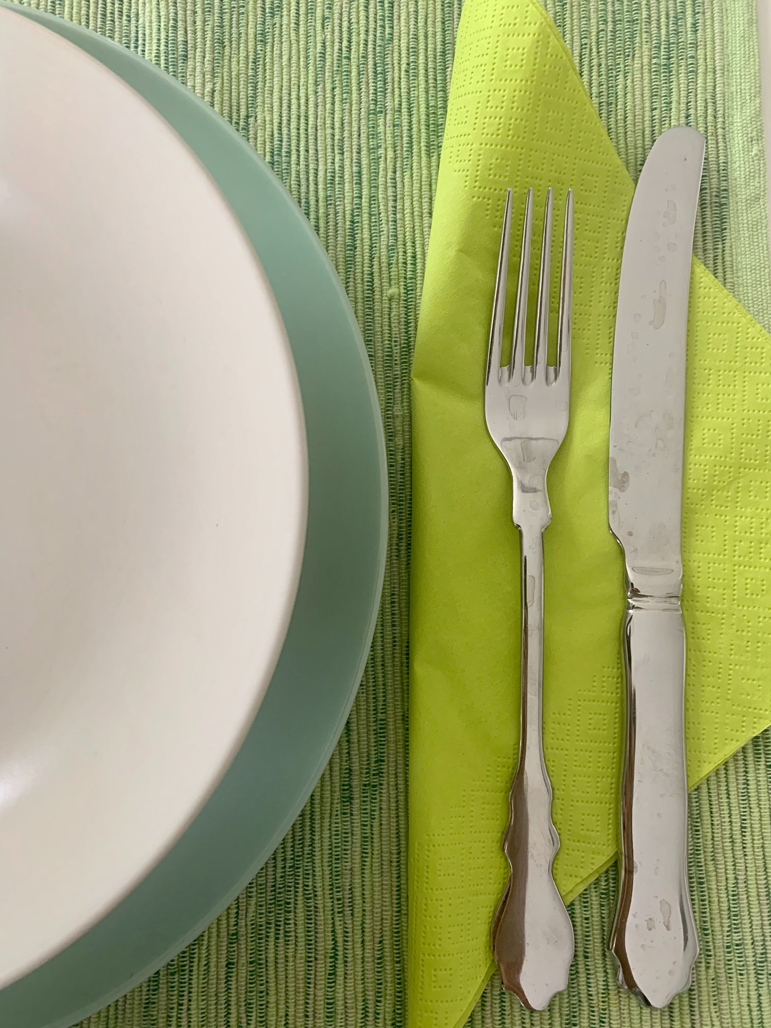 plate, fork, and knife on napkin