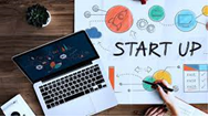 a laptop and an infographic that says start up