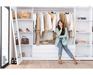 a custom closet with a woman thinking about how to organize it