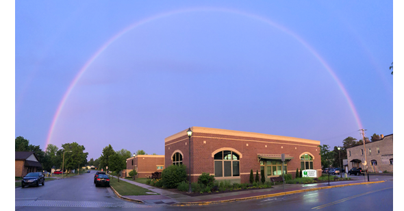 Picture of a full rainbow over E.D. Locke Public Library.