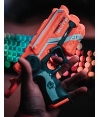 Photo of a person holding a Nerf gun by Alex Kalligas on Unsplash.
  