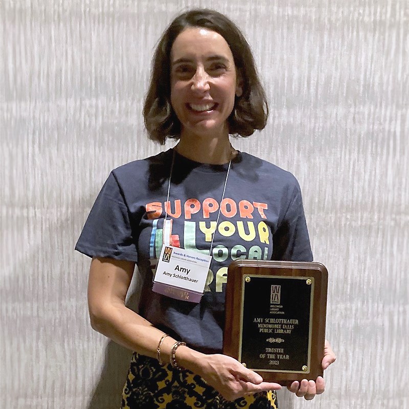 Photo of Amy Schlotthauer holding her Trustee of the Year award.