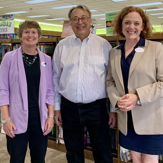 Photo of three people smiling at the camera inside the library. From left to right: Director Cathy Tuttrup, State Representative Tom Michalski, and Deputy Director Betsy Bleck