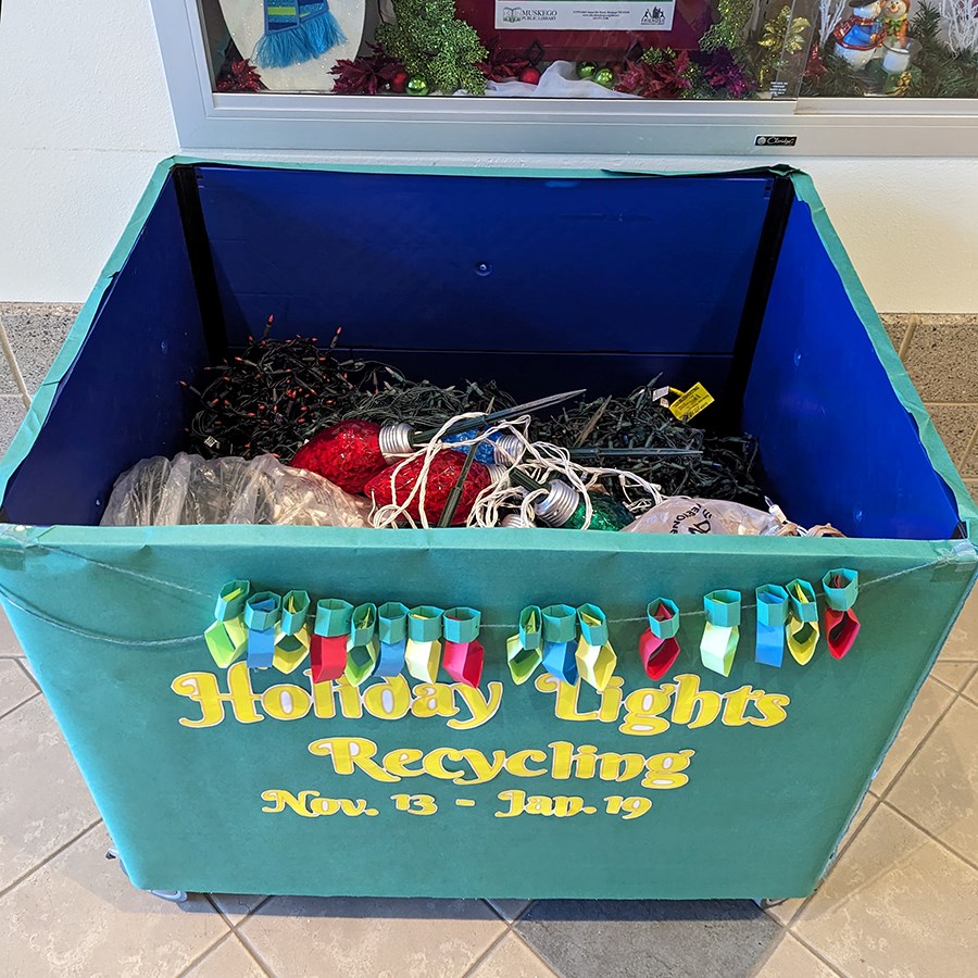 Photo of a large bin labled, "holiday lights recycling - Nov. 3 - Jan. 19" with holiday lights inside.