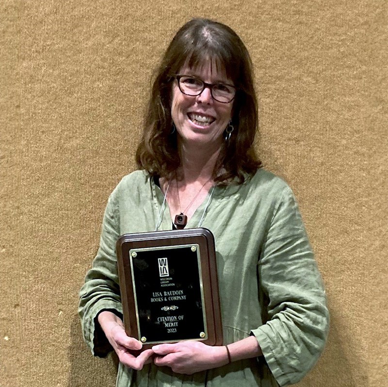 Photo of Lisa Baudoin holding her Citation of Merit award.