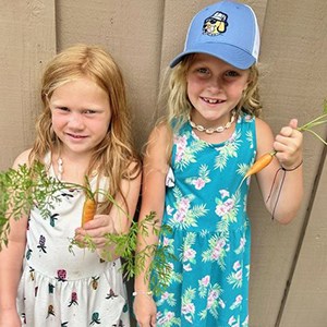 Photo of two children, Avery and Payton, holding little carrots that they grew from seeds they chose from the Brookfield Library's Seed Library. Photo of two children, Avery and Payton, holding little carrots that they grew from seeds they chose from the Brookfield Library's Seed Library.