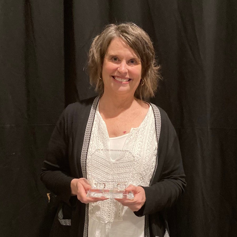 Photo of Connie Meyer holding her Library Hall of Fame Induction award.