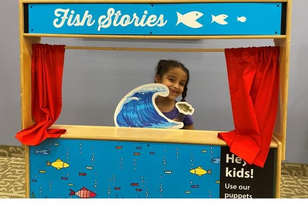 Child playing in Fish Stories booth