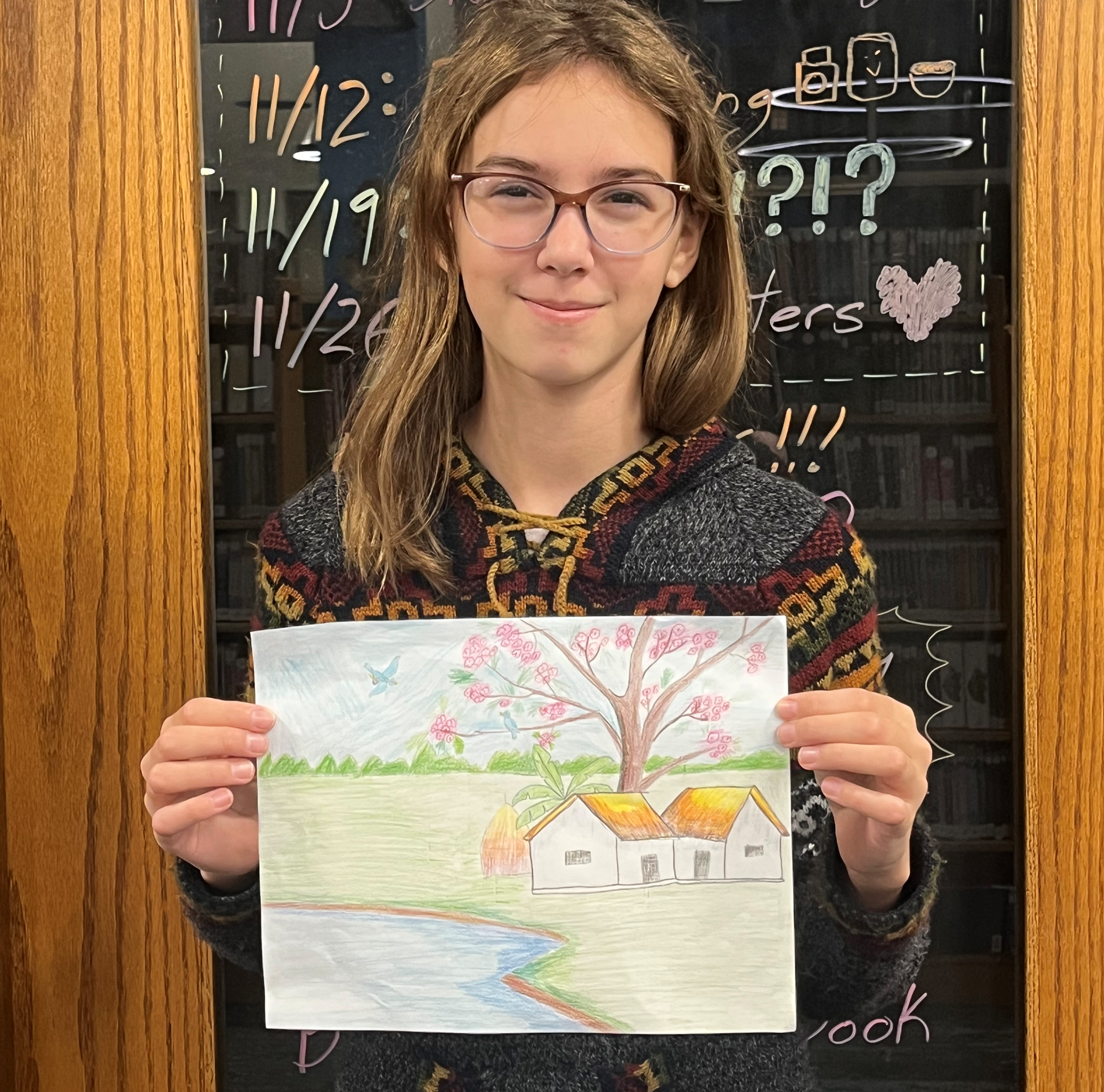The Teen Art Contest winner with her drawing in front of the Teen Scene.