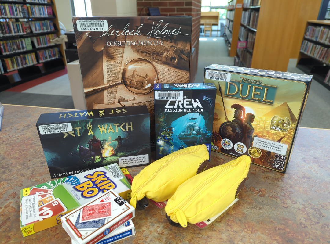 A photograph of a selection of board games, including Sherlock Holmes: Consulting Detective, 7 Wonders Duel, Set a Watch, The Crew: Mission Deep Sea, Skip-Bo, two sets of Bananagrams, and two sets of playing cards.