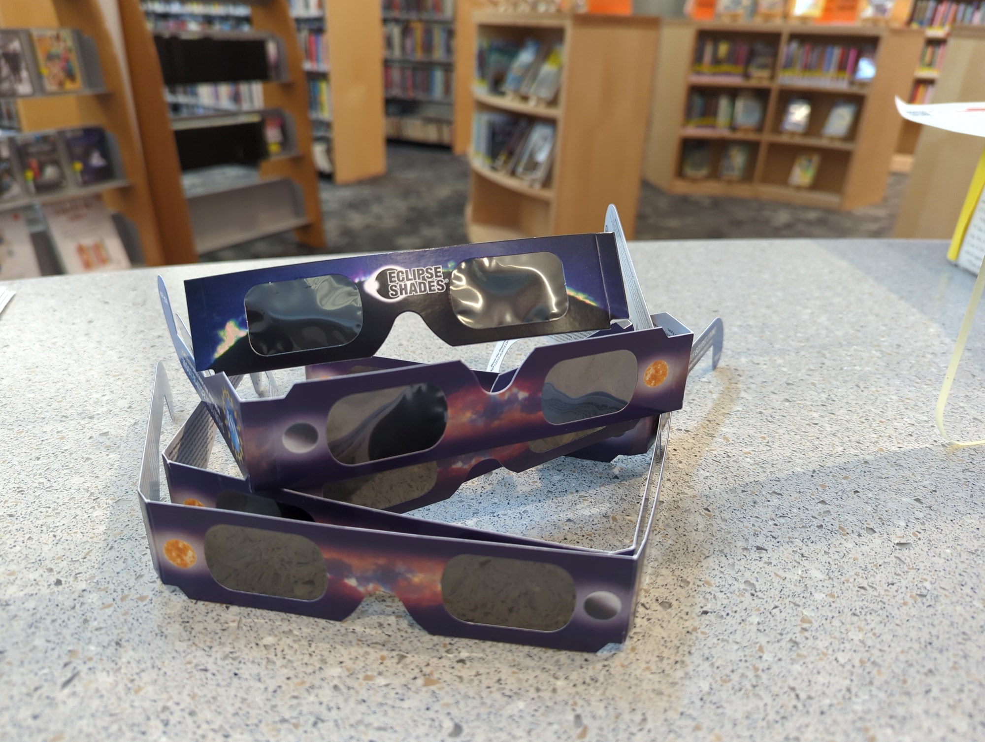 Photograph of a stack of donated eclipse glasses