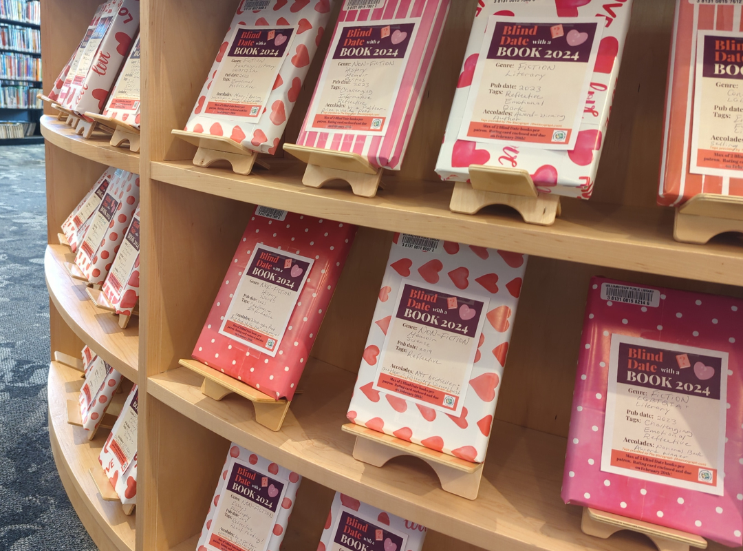 A photograph of books wrapped in pink Valentine's day themed wrapping paper as part of our Blind Date With a Book reading activity.
