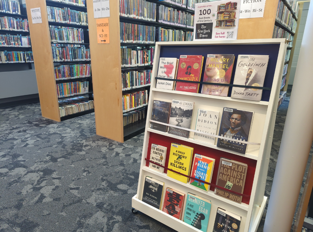 Photograph of a book display with face-out books selected from the New York Times top 100 books of the century.