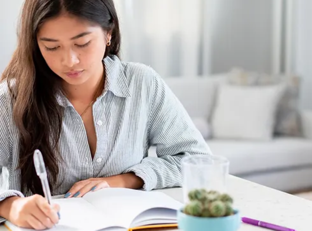 Photograph of young adult writing college essay