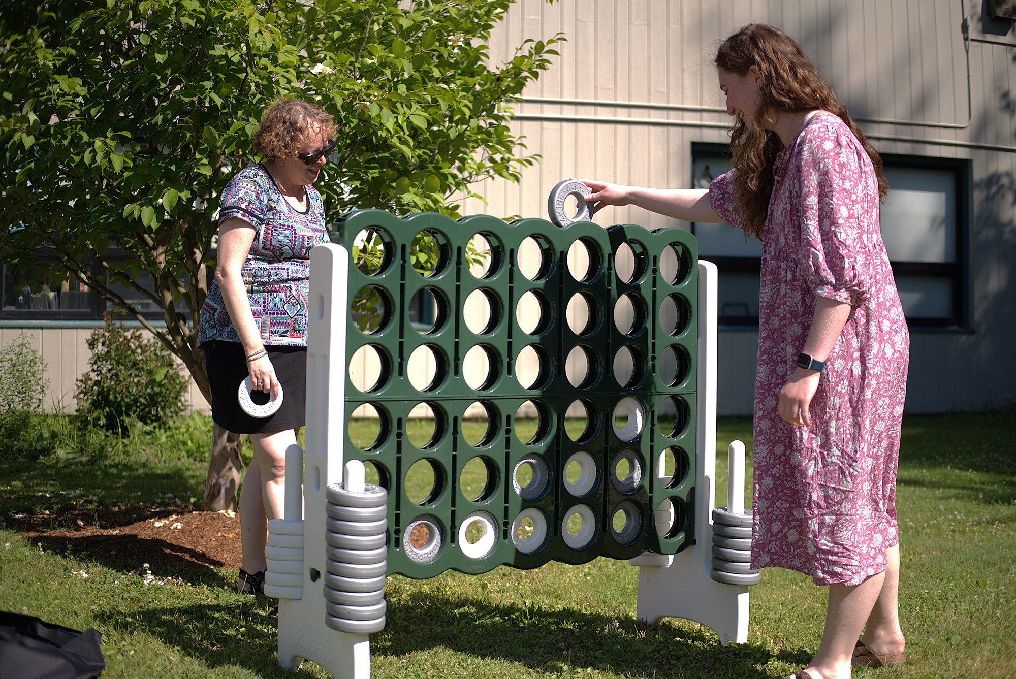 A photo of a collection of outdoor toys and games, including giant Connect 4, giant Scrabble, ring toss, and more!